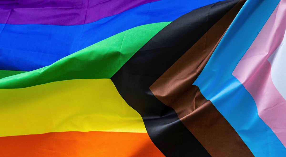 Progress Pride flag fabric close-up representing gender affirmation and transition ceremonies in Bognor Regis